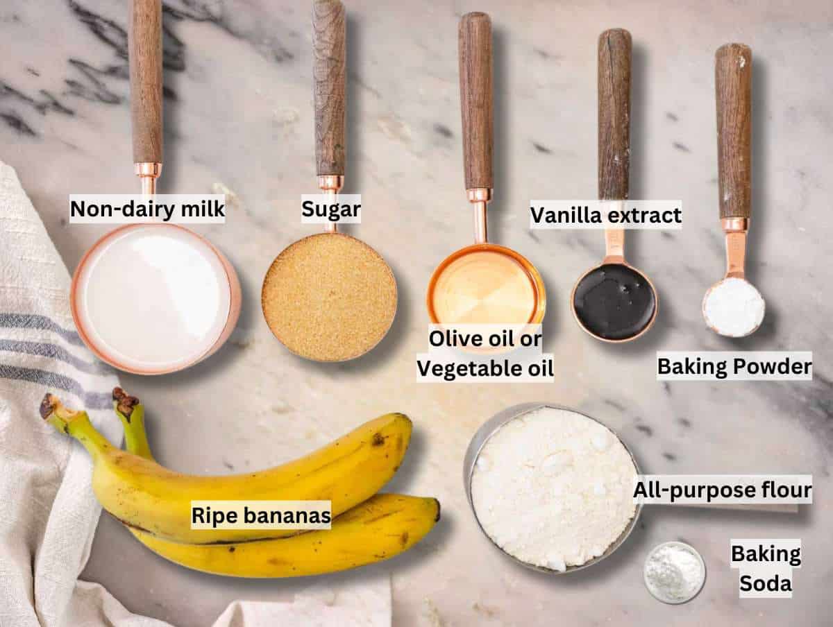 Ingredients for healthy banana muffins on a marble table.