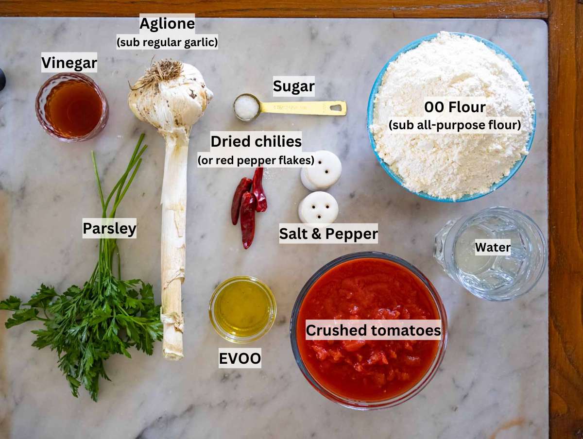 Ingredients to make homemade pici and aglione sauce