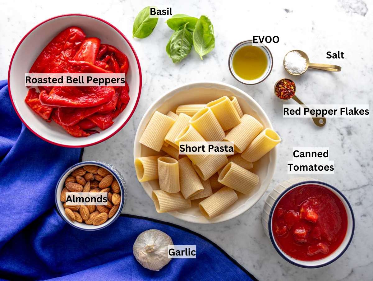 Red pepper pasta ingredients on a marble table.