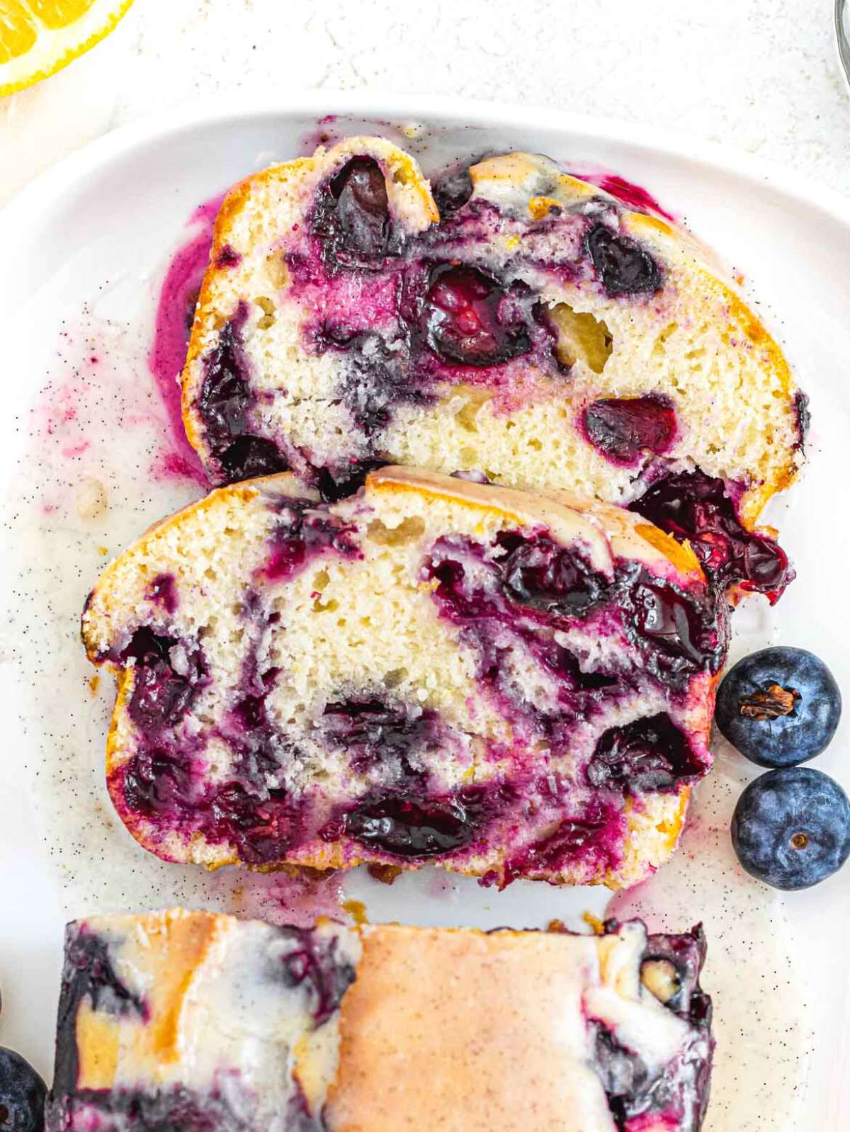 Slices of blueberry pound cake with moist and jammy blueberries.
