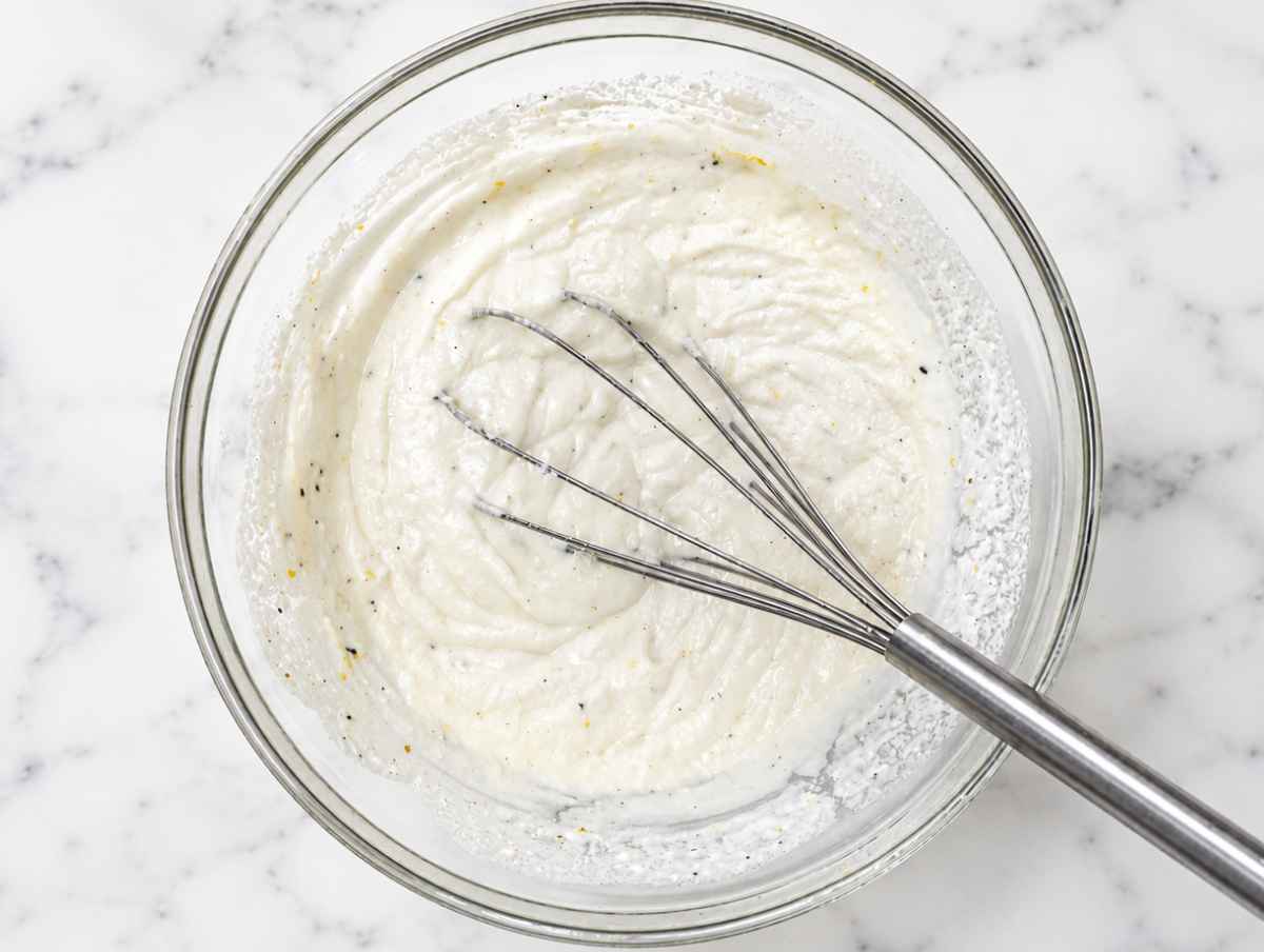 Step 2 Ricotta, Parmesan, lemon zest, and pasta water whisked into creamy sauce.