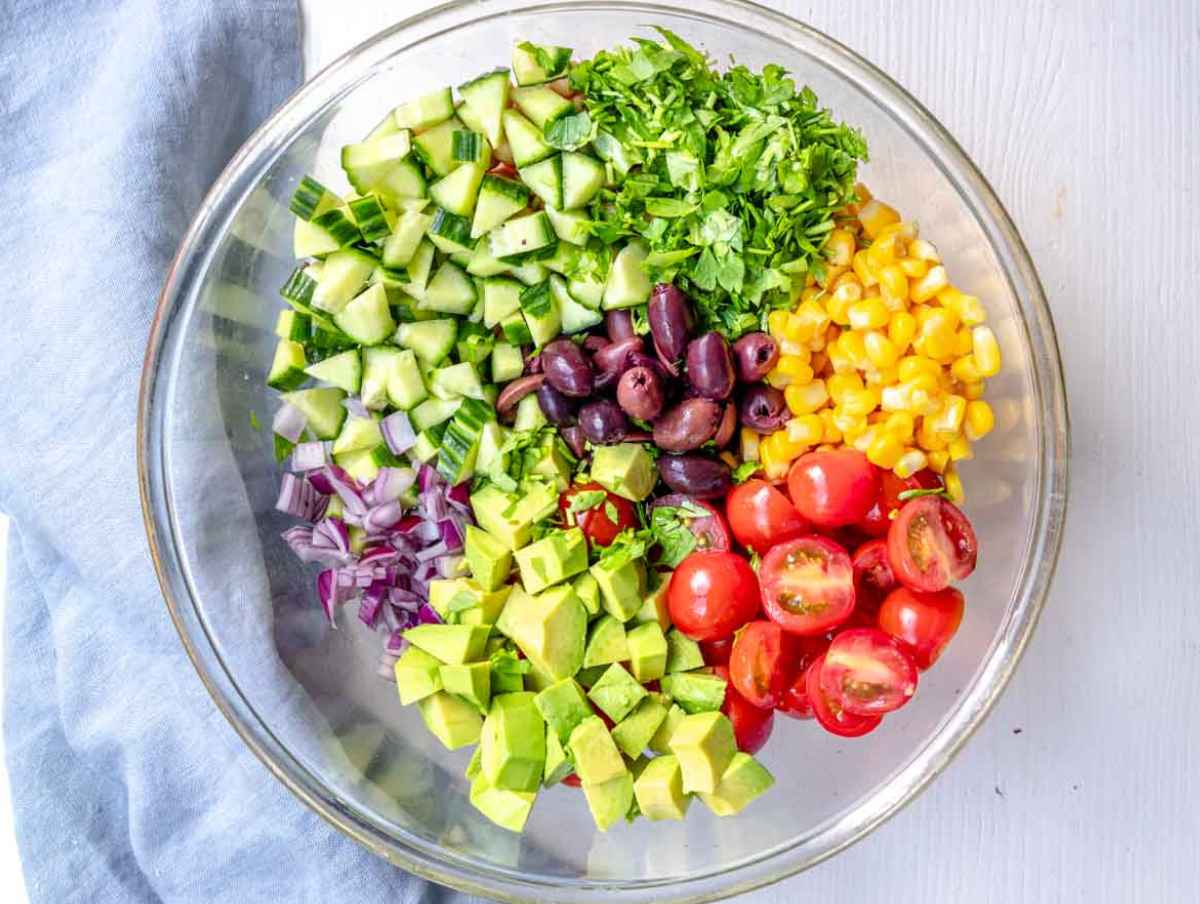 Step 3 Chopped tomatoes, cucumber, corn, olives, onion, parsley, and avocado.