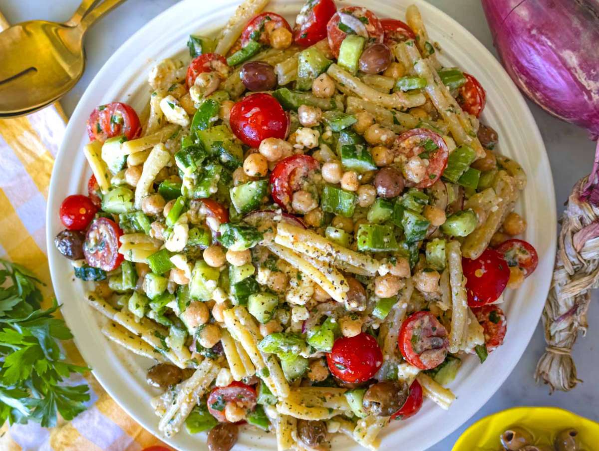Step picture 4 Serving the Greek pasta salad on a white platter.