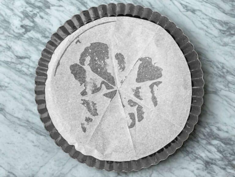 Tart pan lined with parchment paper.