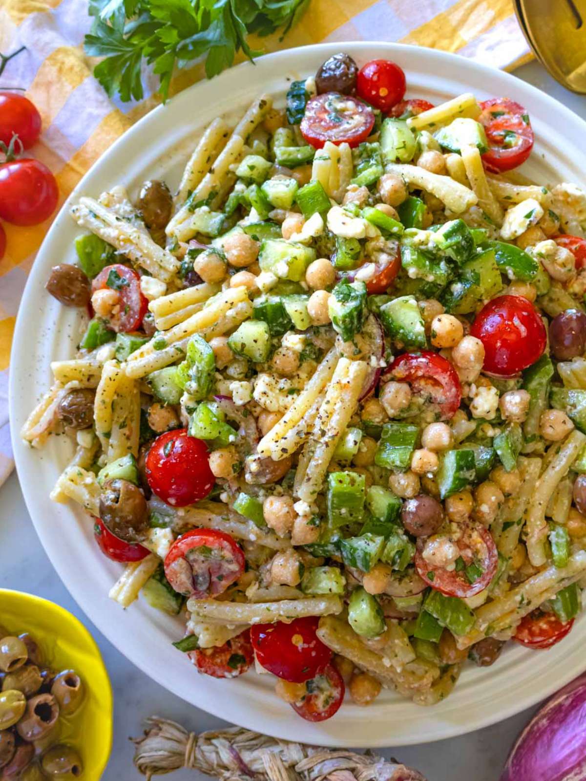 Top-down view of Greek pasta salad with feta, olives, and fresh vegetables – easy make-ahead Mediterranean lunch idea.