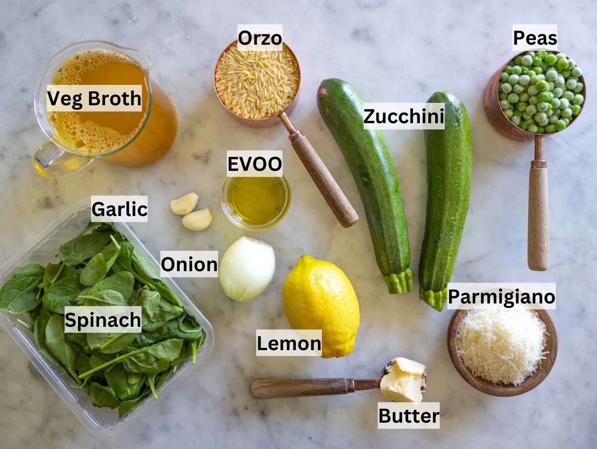 All ingredients for lemon orzo with zucchini laid out on a wooden surface.