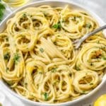 Bowl of Lemon Pasta on white marble with silver fork.