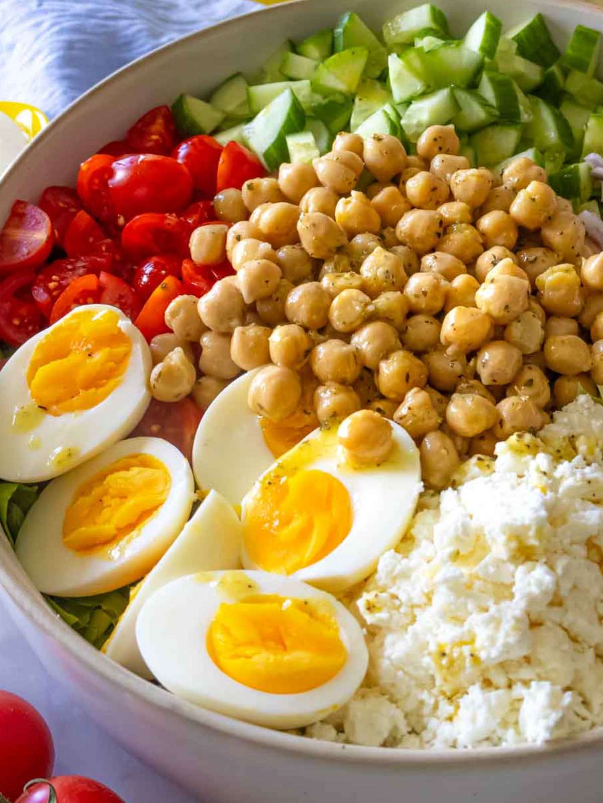 Close-up of Mediterranean chopped salad showing textures of chickpeas, feta, and fresh veggies.