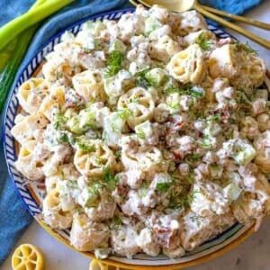 Colorful cold pasta salad with chickpeas and creamy yogurt dressing, perfect for a healthy summer meal.