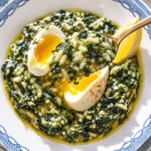 Creamy spanakorizo with spinach, eggs, dill, and lemon in natural light.