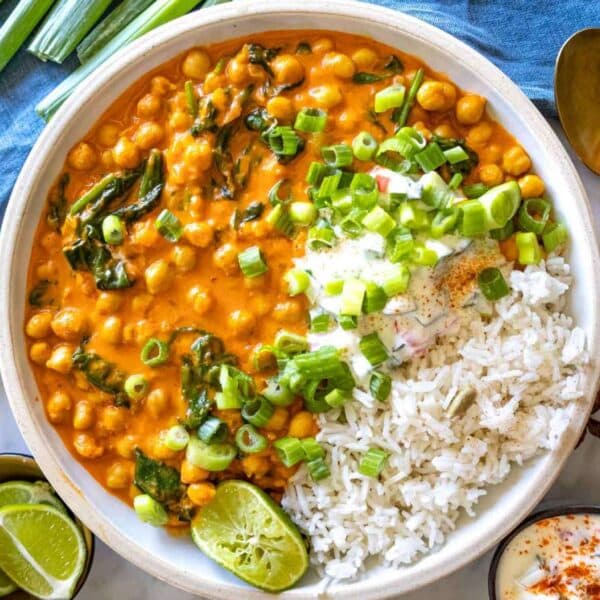 Finished curry served in a bowl with basmati rice and lime juice.