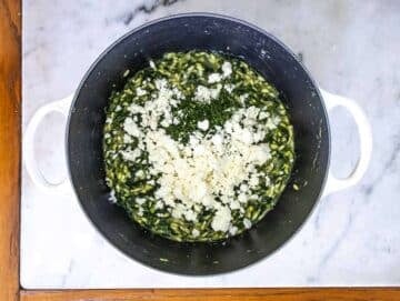 Fresh dill lemon zest and feta stirred into spanakorizo final flavor boost for Mediterranean rice dish.