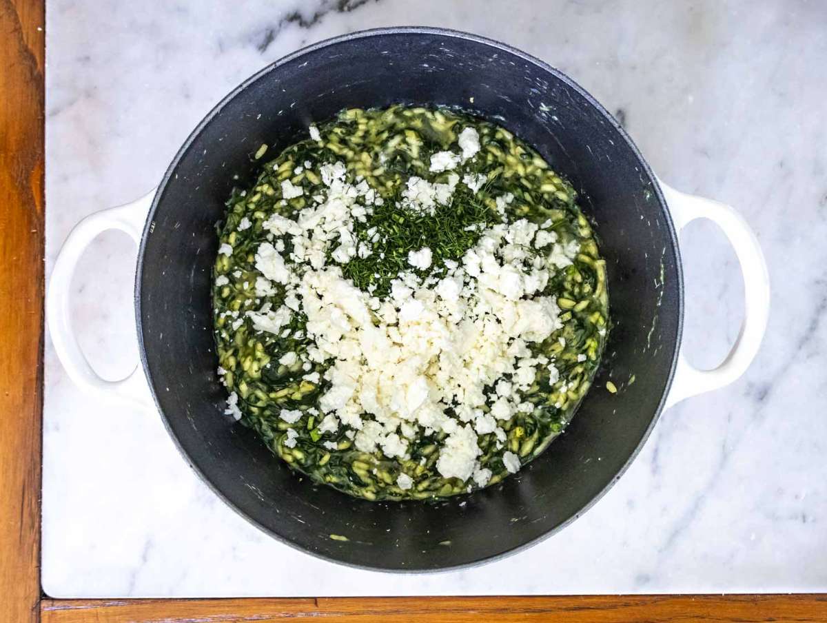 Fresh dill lemon zest and feta stirred into spanakorizo final flavor boost for Mediterranean rice dish.