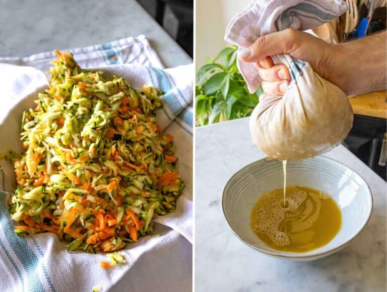 Hands wringing out grated zucchini and carrot mixture in a clean kitchen towel.