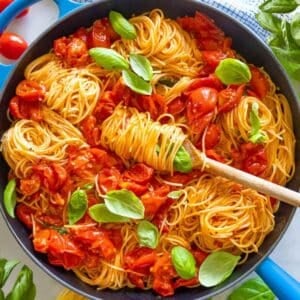 Healthy angel hair pasta with fresh tomatoes, garlic, and basil—perfect for a light summer dinner.