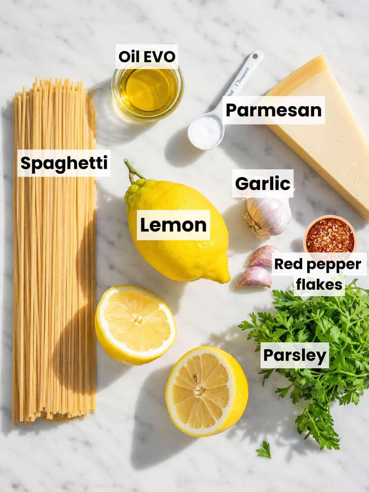 Lemon Pasta ingredients on white marble in bright natural window light.