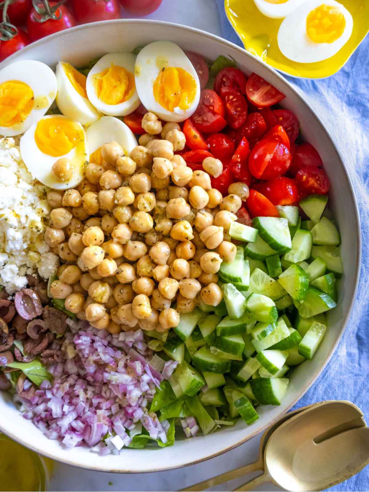 Mediterranean chopped salad served in a bowl with vibrant vegetables and boiled eggs.