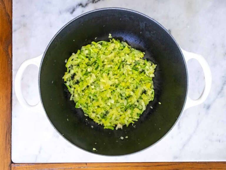 Sautéed onions leeks scallions and garlic in olive oil base for Greek spinach rice recipe.