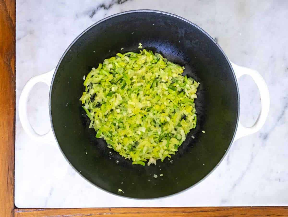 Sautéed onions leeks scallions and garlic in olive oil base for Greek spinach rice recipe.