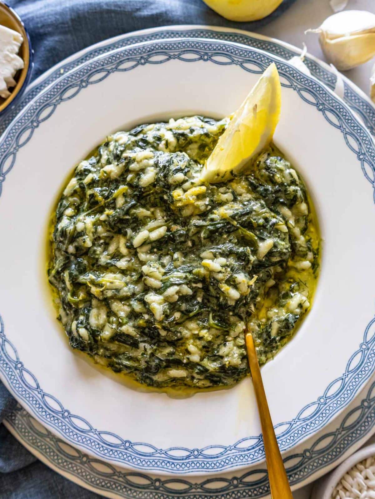 Spanakorizo served in a bowl with lemon and dill one-pot Greek spinach and rice recipe.
