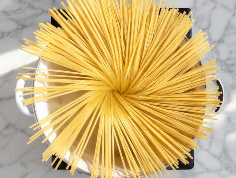 Step 1 Spaghetti boiling in salted water on marble counter top.