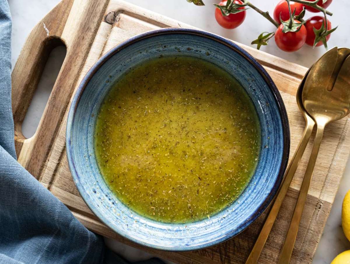 Step 2 - Whisking lemon oregano dressing in a bowl for Mediterranean chopped salad