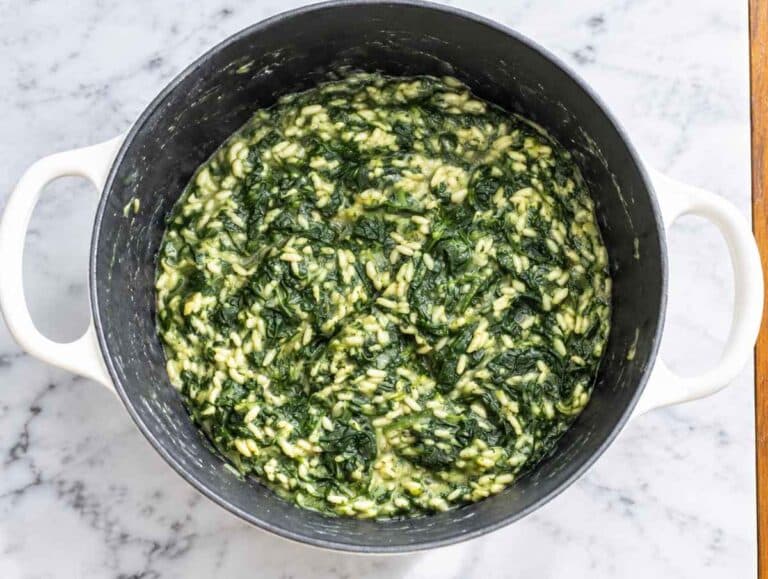 Step 3 Rice and broth simmering with spinach until tender and creamy.