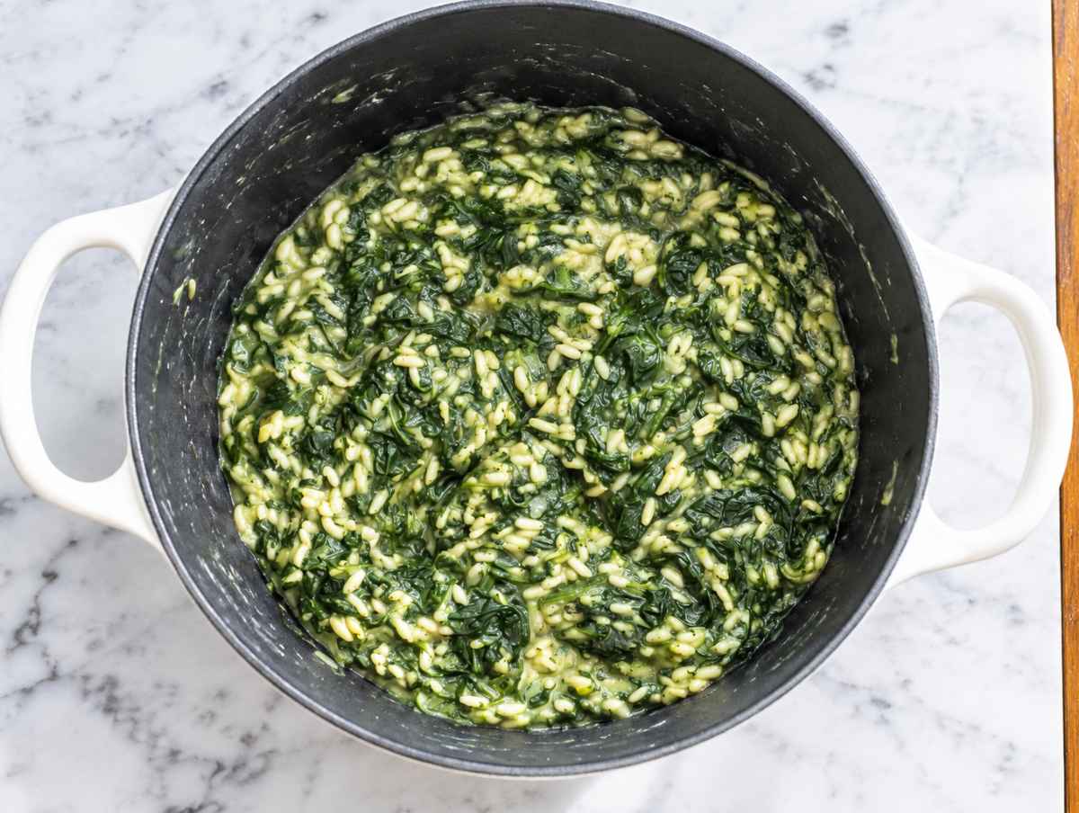 Step 3 Rice and broth simmering with spinach until tender and creamy.