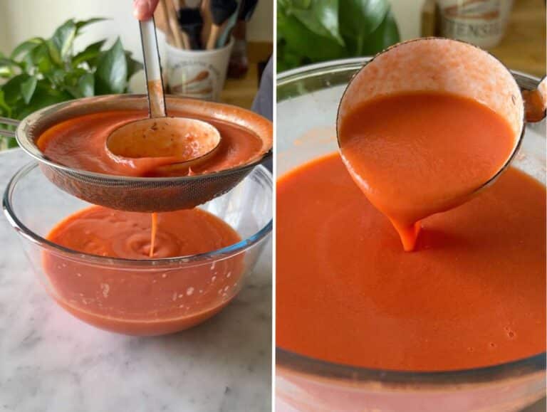 Straining gazpacho through a sieve into a bowl.