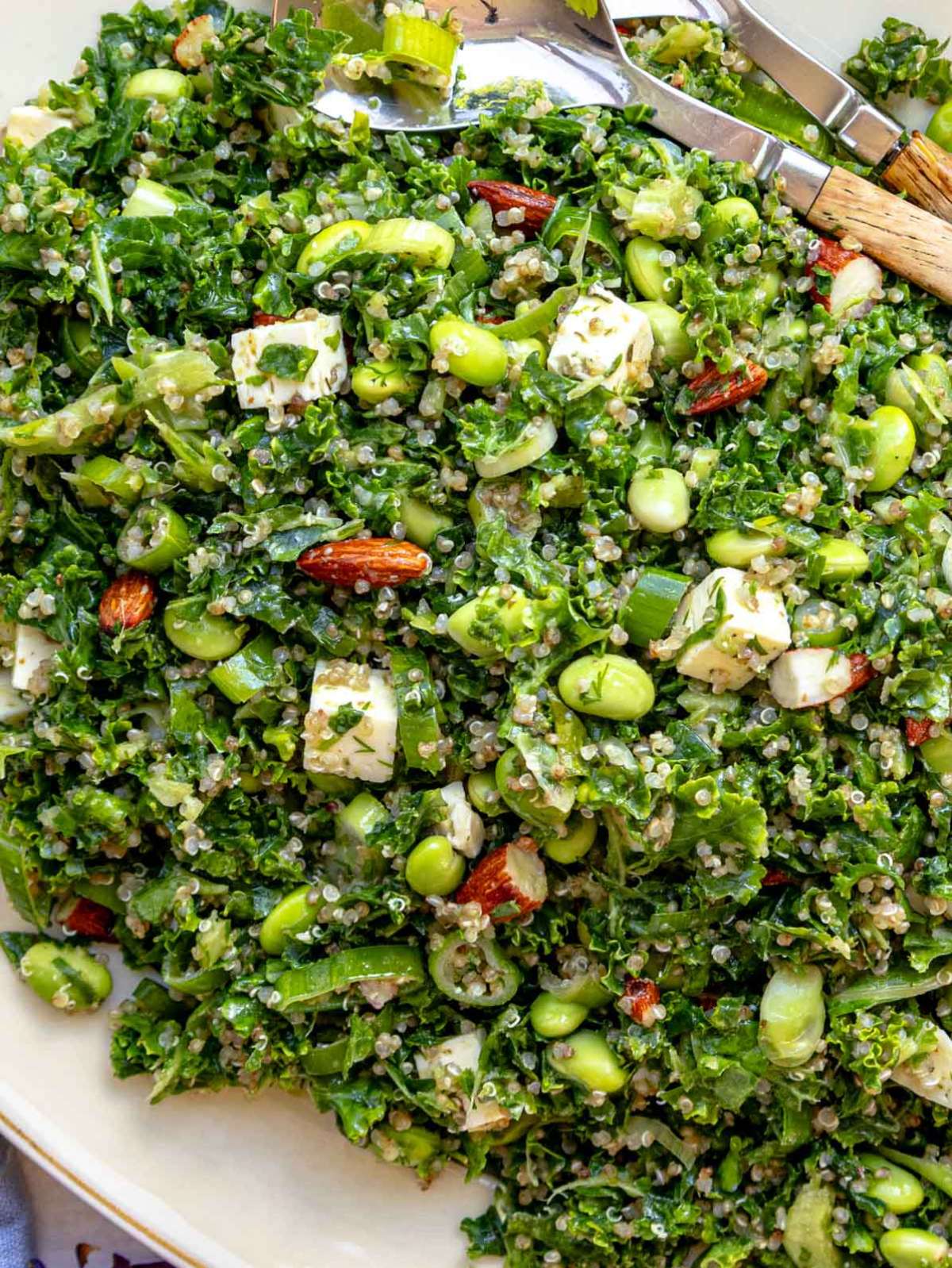 Top-down view of kale quinoa salad served on a large platter, perfect for a healthy plant-based lunch or vegetarian meal prep