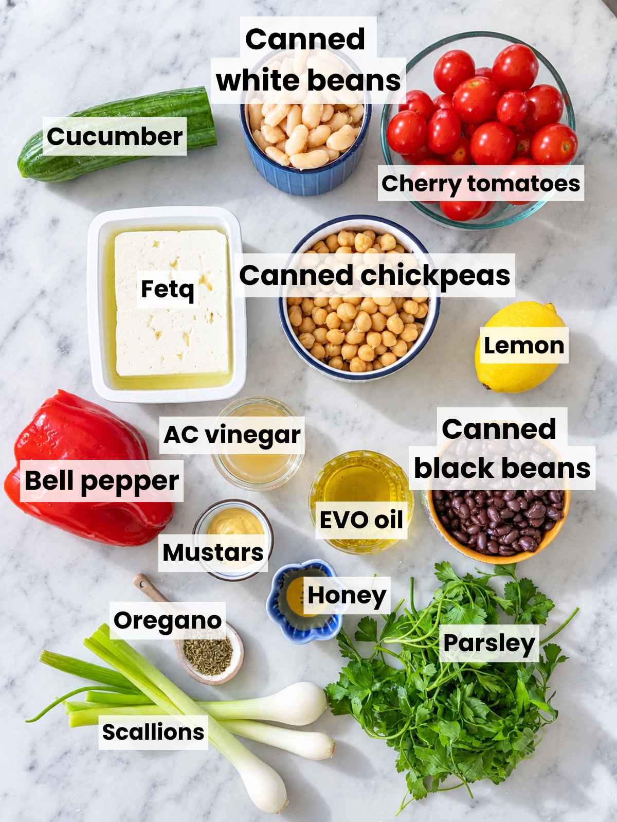Chickpeas, black beans, cannellini beans, vegetables, feta, herbs, and dressing ingredients.