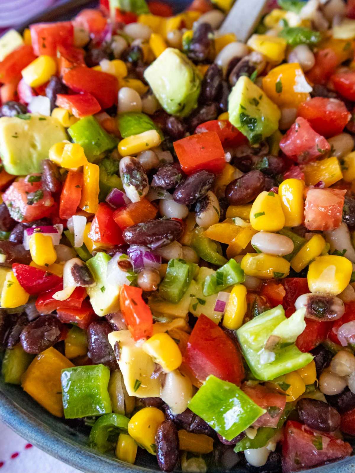 Close up of Cowboy Caviar dip with avocado beans corn and peppers.