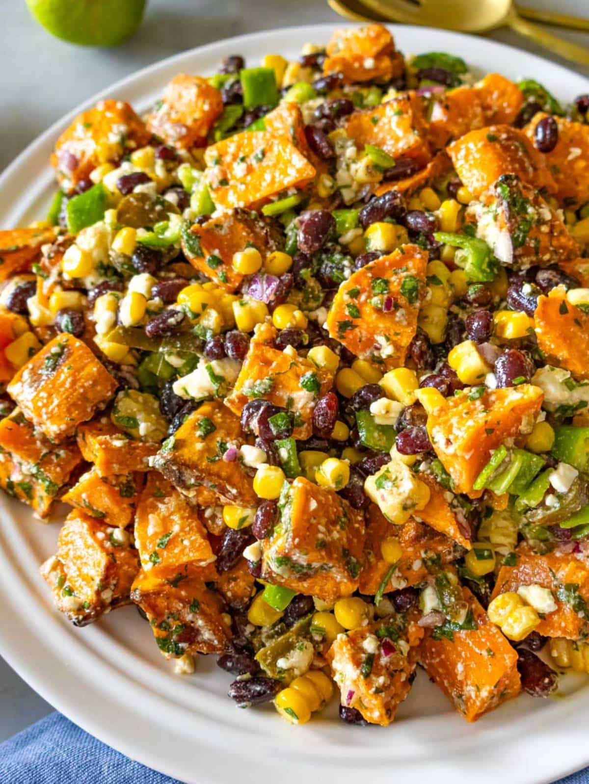 Close up of black bean corn salad with cilantro lime dressing and colorful veggies.