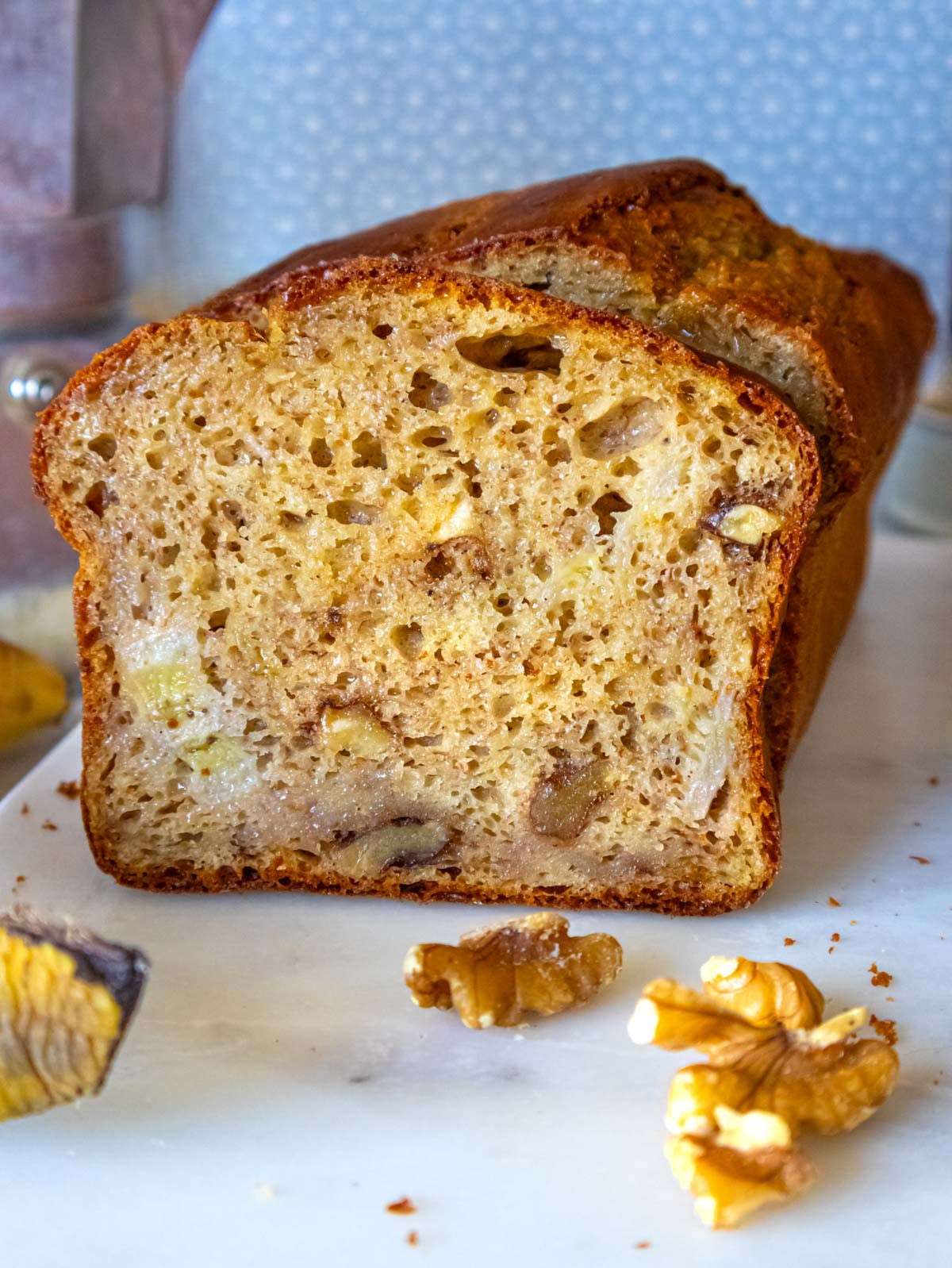 Close up of moist protein banana bread slices with walnuts and extra banana pieces.
