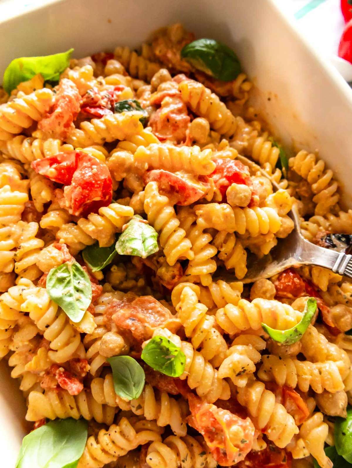 Creamy baked feta pasta with bursting cherry tomatoes and golden chickpeas.