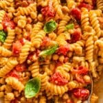 Creamy feta pasta with chickpeas after mixing in a casserole.
