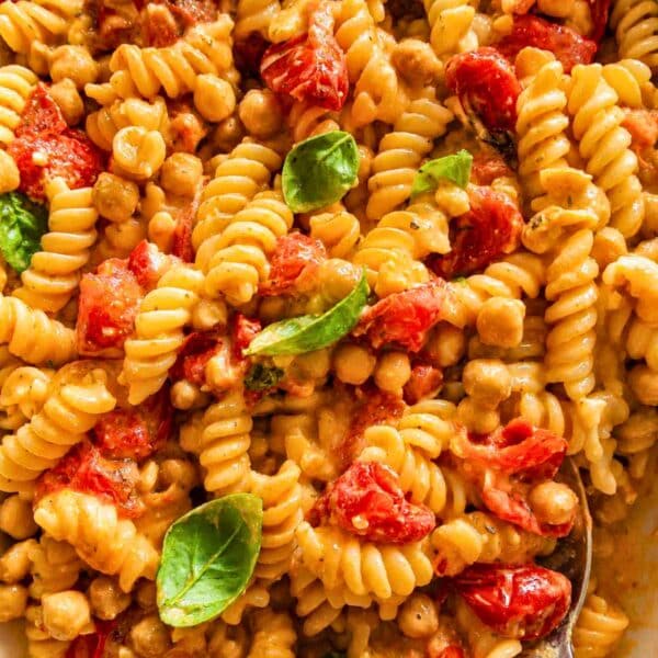 Creamy feta pasta with chickpeas after mixing in a casserole.