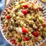 Greek Orzo Salad served on a large platter with lemon dressing.