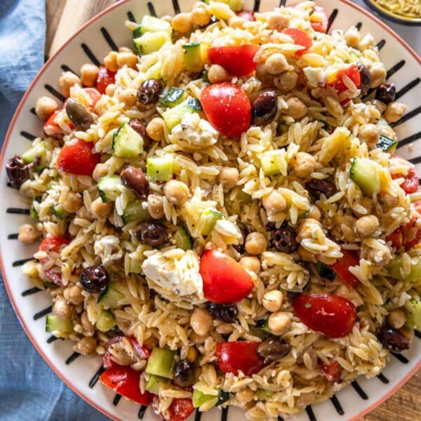 Greek Orzo Salad served on a large platter with lemon dressing.