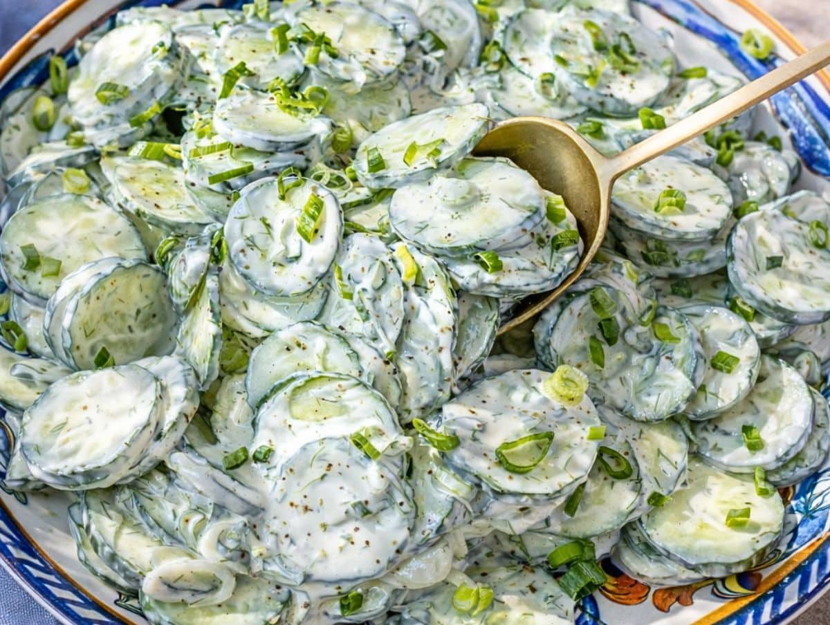 Greek yogurt recipe with cucumber and a golden spoon.