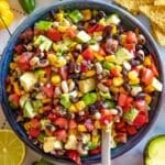 Healthy Cowboy Caviar with black beans corn peppers and avocado in a bowl.