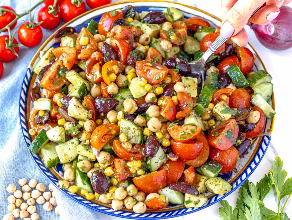 Healthy chickpea cucumber salad on a summer table with lemon and olive oil dressing.