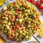 Healthy pesto pasta salad with marinated butter beans served with shaved parmesan.