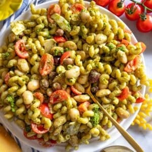 Healthy pesto pasta salad with marinated butter beans served with shaved parmesan.