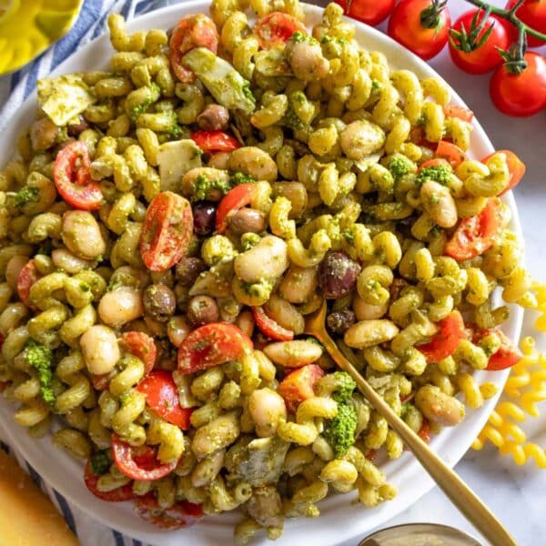 Healthy pesto pasta salad with marinated butter beans served with shaved parmesan.