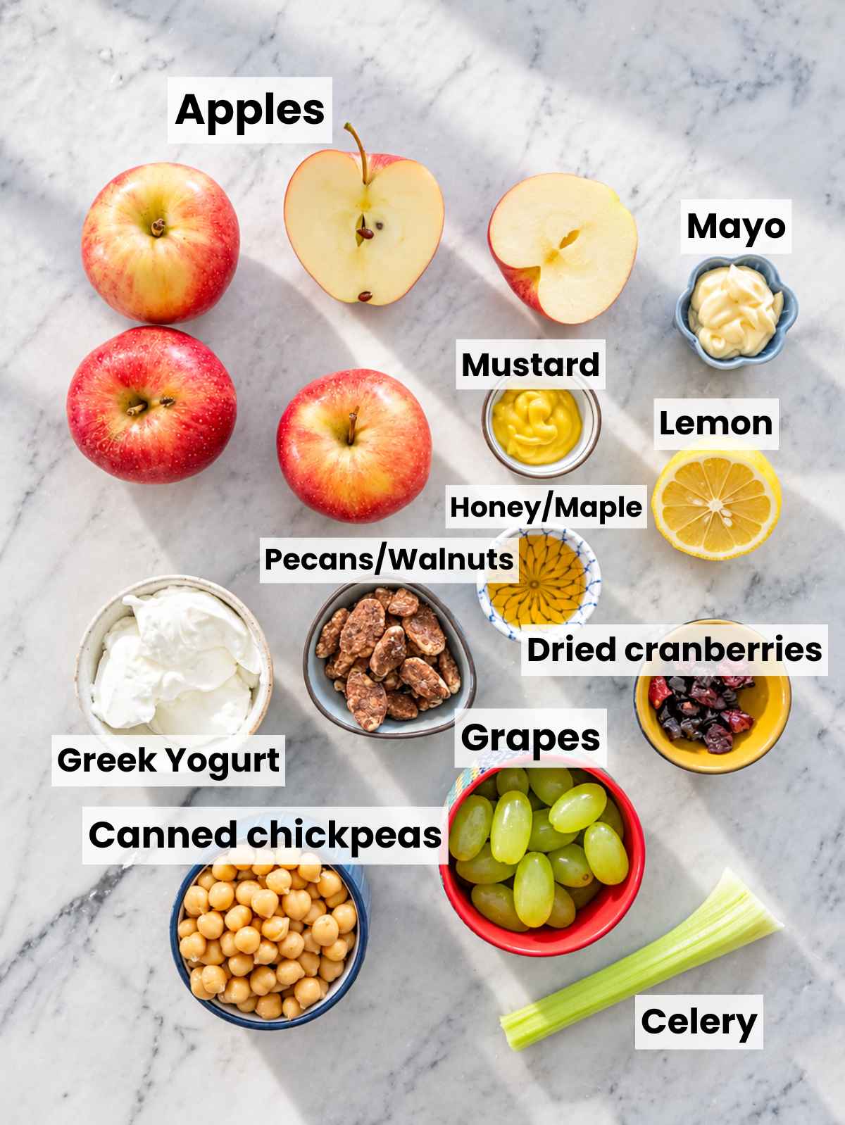 Ingredients for apple chickpea salad prepared on a table.