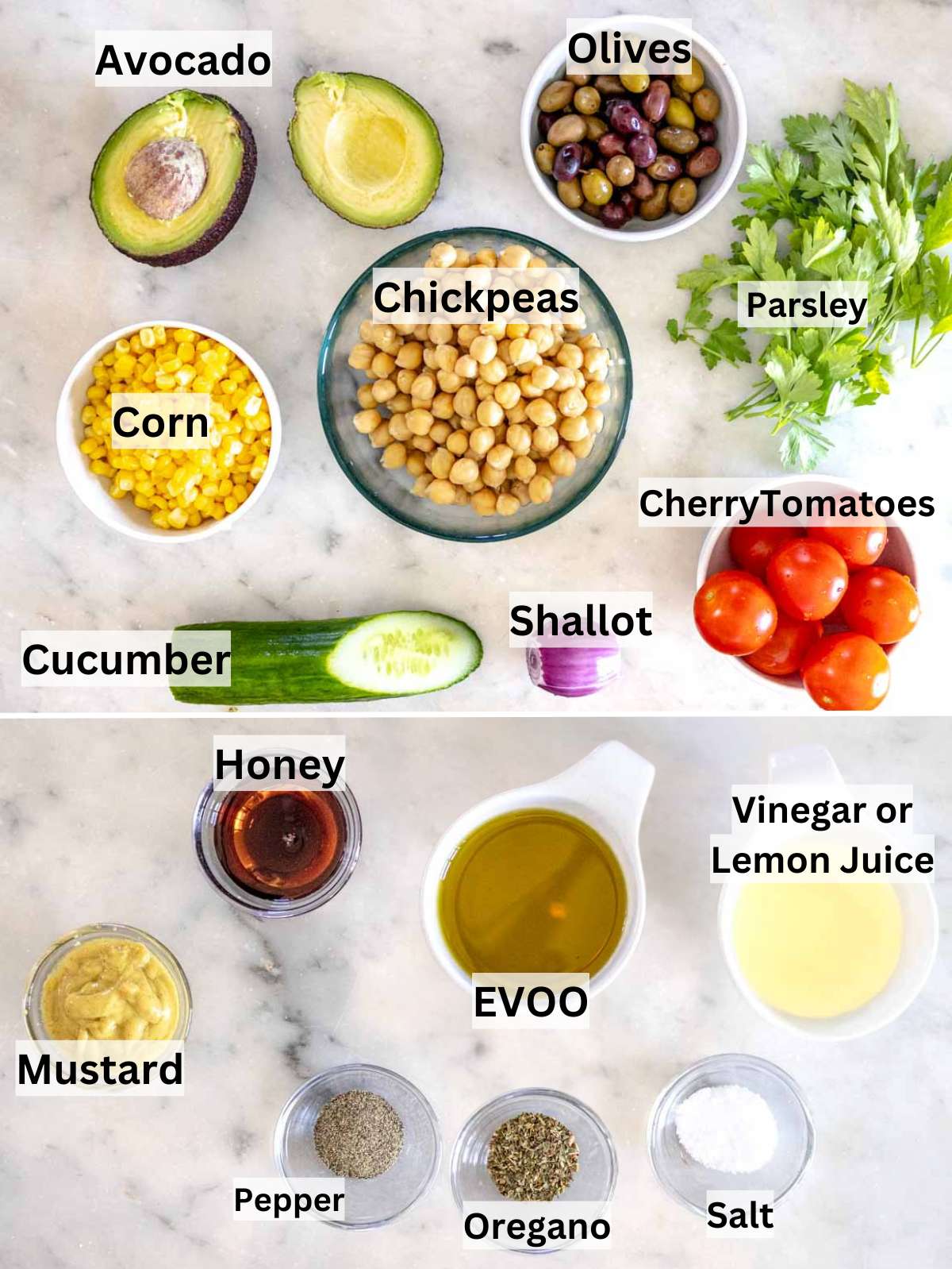 Ingredients laid out for chickpea cucumber salad with chickpeas cucumber tomatoes olives avocado and herbs.