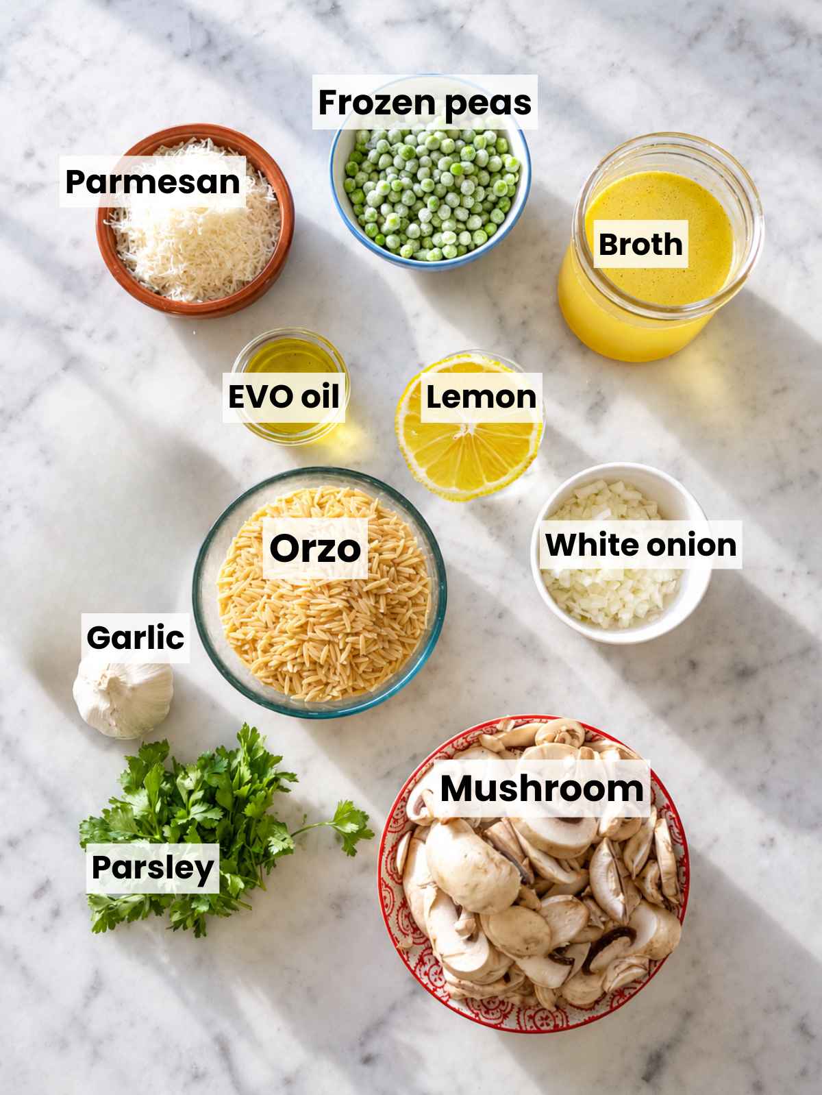 Mushroom orzo ingredients with mushrooms, orzo, peas, Parmesan, and parsley.