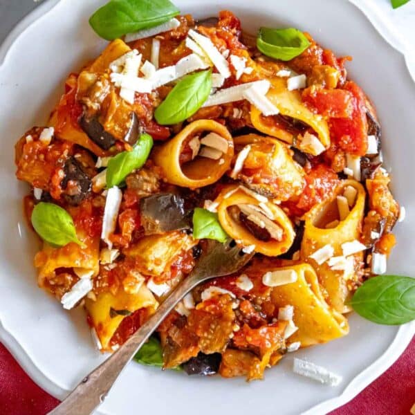 Sicilian pasta alla Norma served warm with golden roasted eggplant and fresh summer basil.