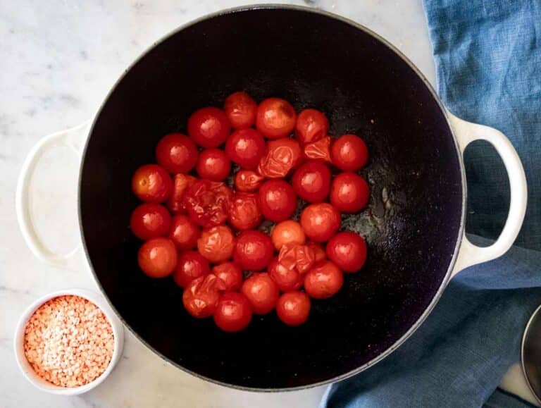 Step 1 Blistering cherry tomatoes in olive oil in a Dutch oven.